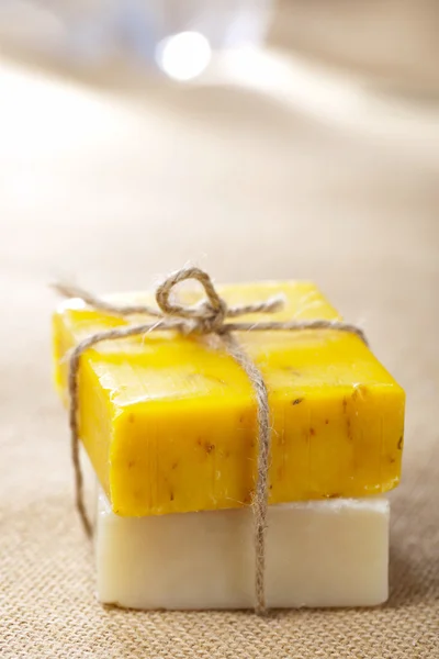 stock image Natural homemade herbal soap bars tied, on jute backdrop