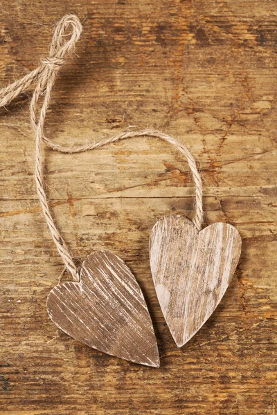 Tied wooned hearts on old wood — Stock Photo, Image