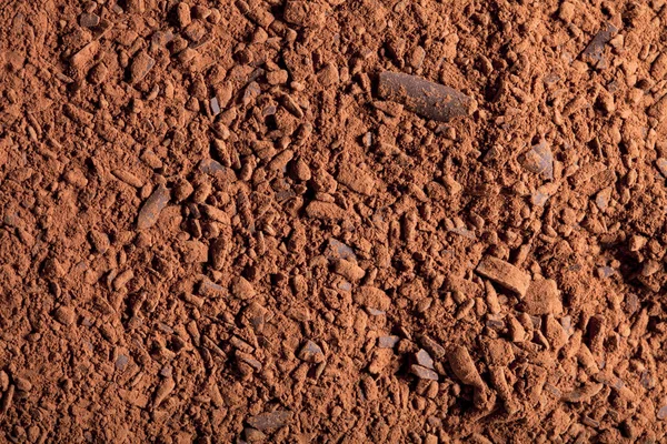Cocoa powder with small pieces of chocolate background — Stock Photo, Image