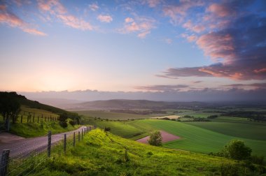 Beautiful English countryside landscape over rolling hills clipart