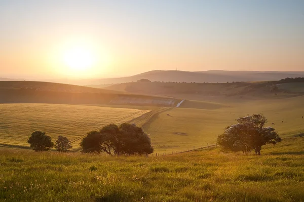Salida del sol de verano sobre el paisaje rural inglés — Foto de Stock