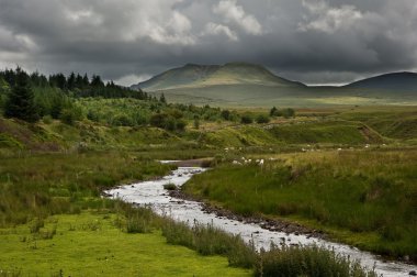 Countryside landscape image across to mountains in distance with clipart