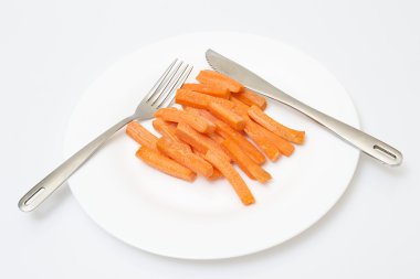 Fresh juicy slices of carrot on white plate