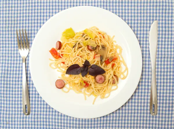 Stock image Spagetti with zucchini, mushrooms, sauce, cheese, sausage on a plate.