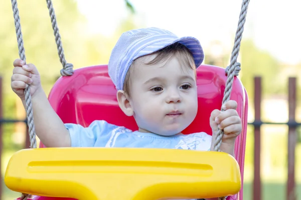 Baby boy swinging — Stock Photo, Image