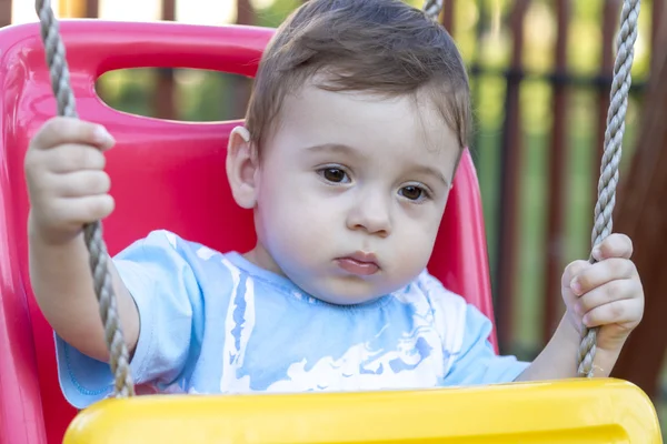 Baby boy in swing — Stock Photo, Image