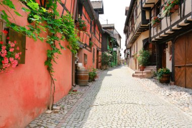 Alley in medieval Riquewihr town, France clipart