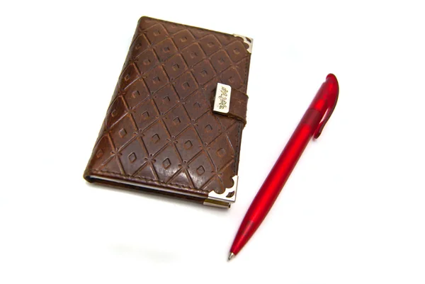 Красная ручка и блокнот — стоковое фото