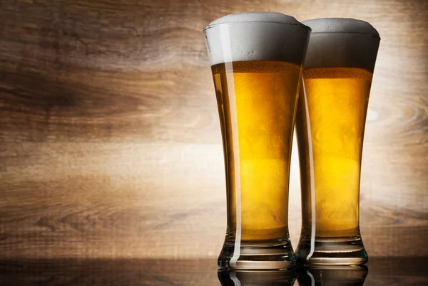 Dos cervezas de vidrio sobre fondo de madera con copyspace —  Fotos de Stock