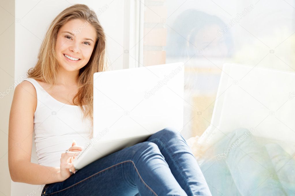 Girl with computer at window