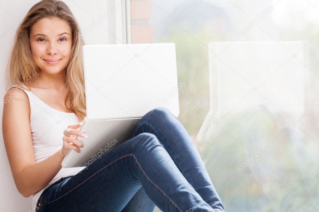 Girl with computer at window