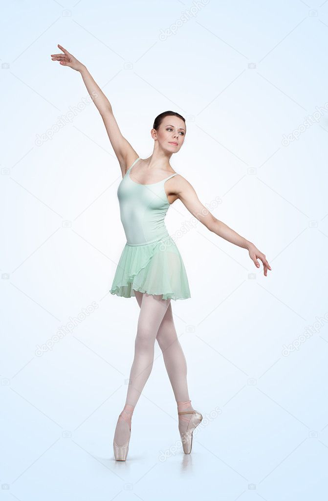 Young beautiful ballerina on a gray background