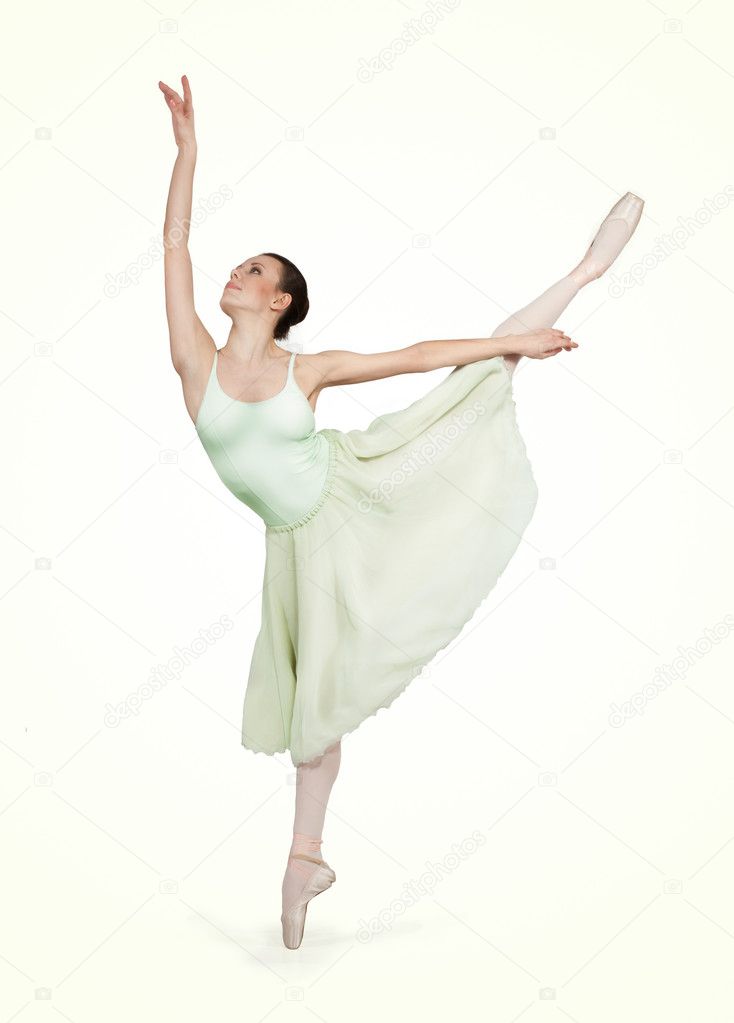 Young beautiful ballerina on a gray background