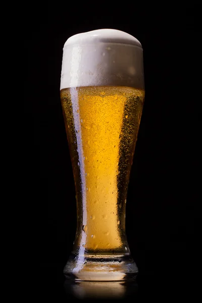 Beer into glass on a black — Stock Photo, Image