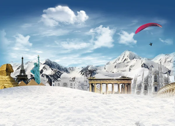 World landmarks among the mountains with snow and man flying in — Stock Photo, Image