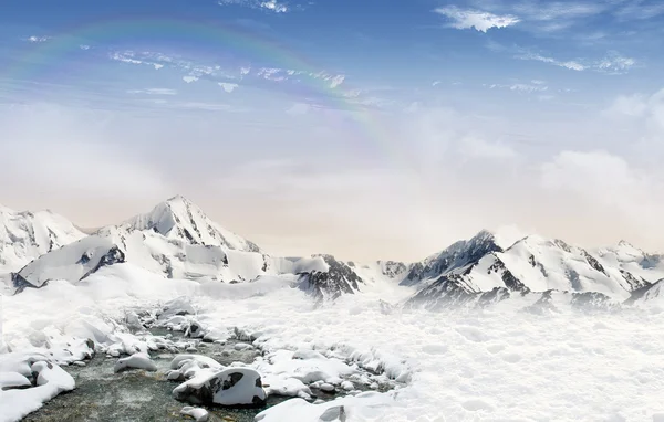 Горный пейзаж со снегом и радугой — стоковое фото