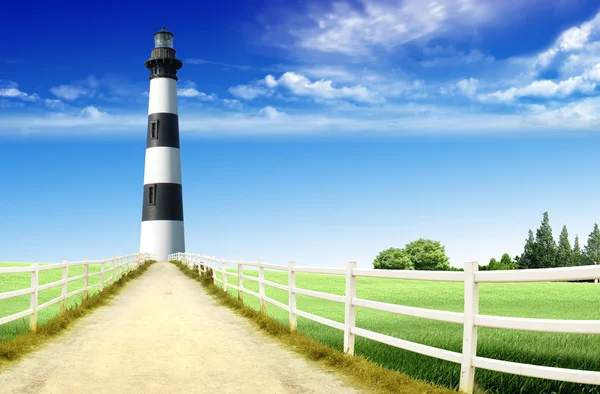 Lighthouse at the end of the road — Stok fotoğraf