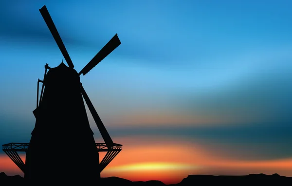 Ветряная мельница на закате — стоковый вектор