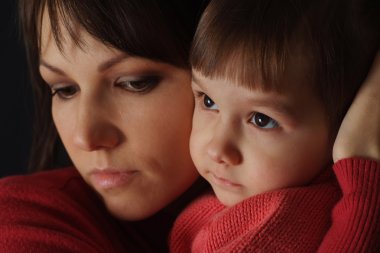 A beautiful caucasian good mother holding her daughter in her ar clipart