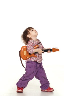 Beautiful little pretty girl plays with a guitar clipart