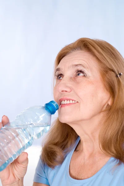 Aged woman with bottle of water — Stock Photo, Image
