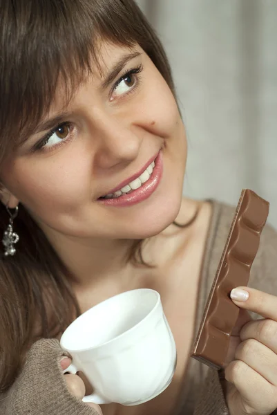 Sorrindo encantadora bela mulher segura em uma mão e uma xícara de — Fotografia de Stock