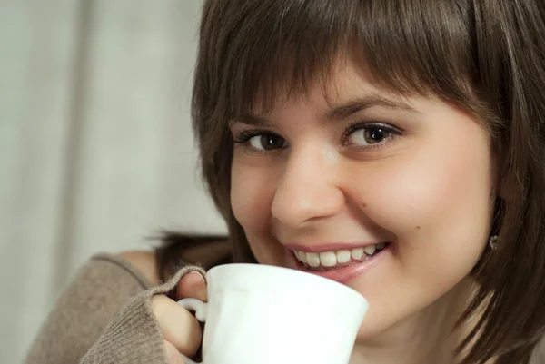 Charming beautiful woman holds a cup — Stock Photo, Image