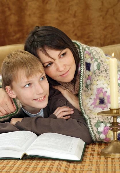 A beautiful Caucasian mom and a charming son sitting — Stock Photo, Image