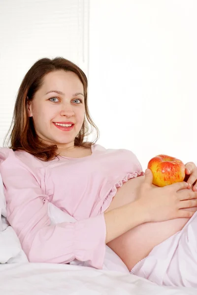 Una mujer embarazada miente —  Fotos de Stock