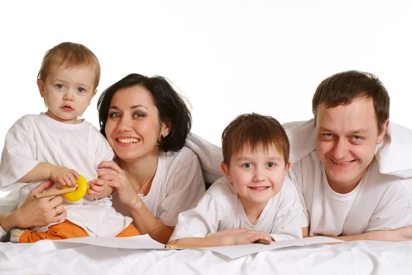 A happy family of four lying — Stock Photo, Image
