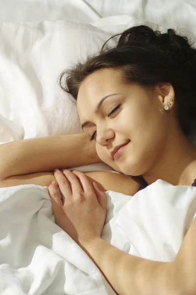 Happy girl lying in bed — Stock Photo, Image