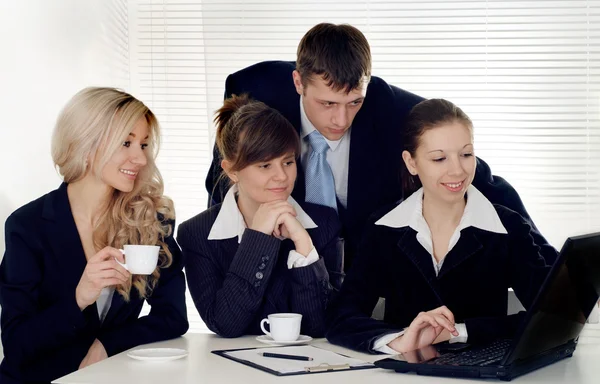 A team of four sitting — Stock Photo, Image