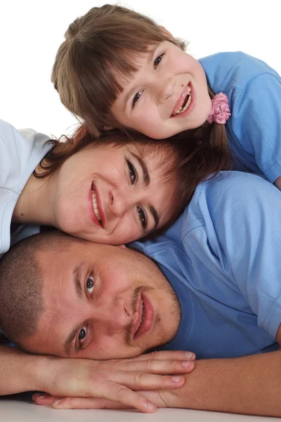Familia feliz de tres mintiendo — Foto de Stock