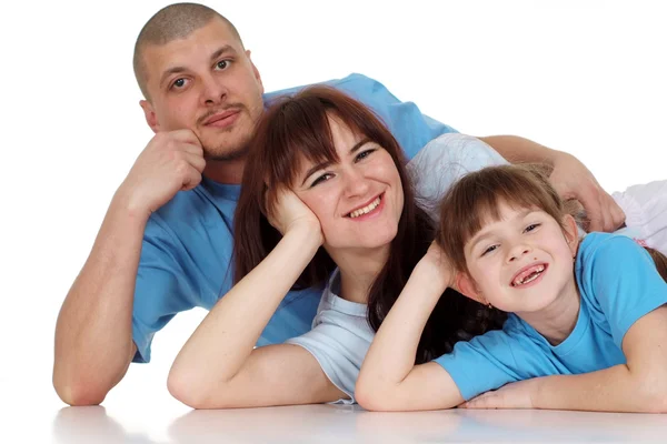 Familia feliz de tres mintiendo —  Fotos de Stock