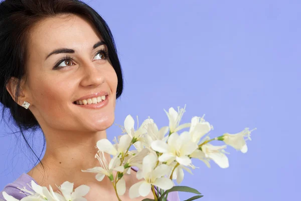 Uśmiech brunetka kaukaski z kwiatami — Zdjęcie stockowe