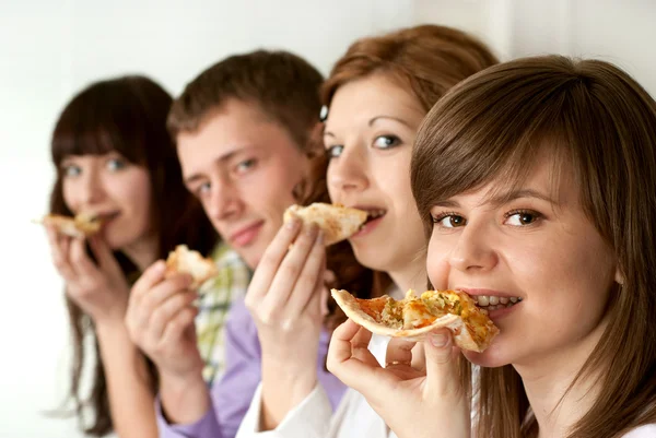 Happy funny Caucasian campaign of four eating pizza — Stock Photo, Image