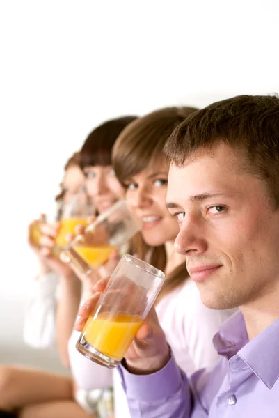 Happy funny Caucasian campaign of four drink juice — Stock Photo, Image