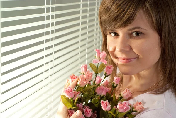 Beautiful nice Caucasian woman standing with flowers — Stock Photo, Image