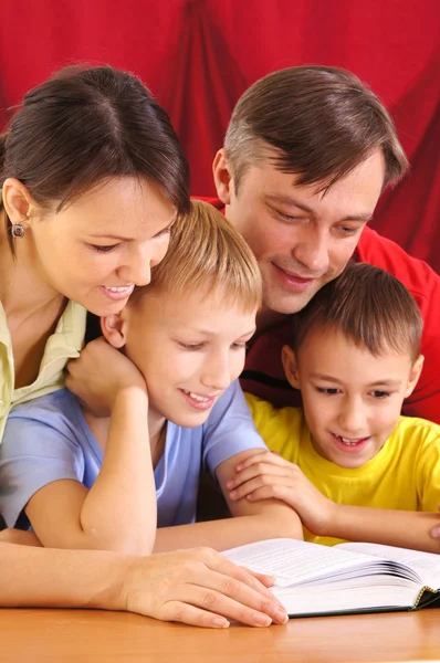 Reading family on red — Stock Photo, Image