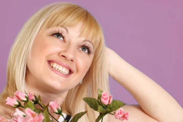 Portrait of a beautiful blonde Caucasian happy lady with flowers — Stock Photo, Image