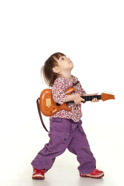 Красивая маленькая красивая девочка играет на гитаре — стоковое фото