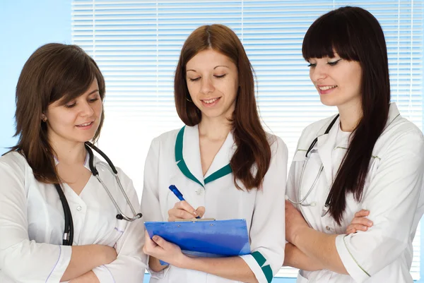Drei charmante Krankenschwestern mit Personal — Stockfoto