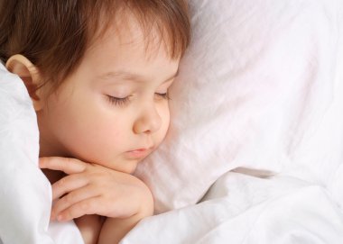 A small charming baby sleeps clipart