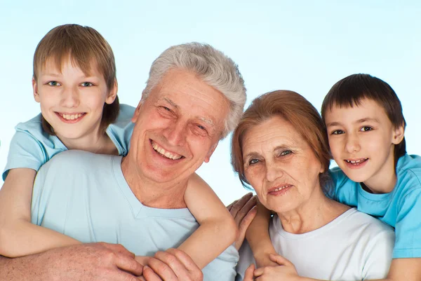 Happy good Caucasian grandparents with grandchildren fooled — Stock Photo, Image