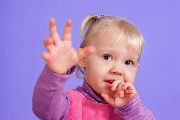 A small charming Caucasian toddler plays — Stock Photo, Image