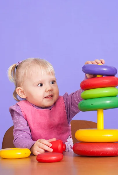 A little charming Caucasian toddler plays with toy — Stock Photo, Image