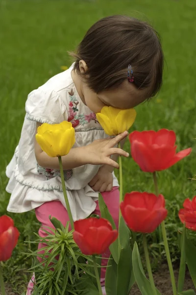 Un bébé caucasien heureux dans les fleurs — Photo