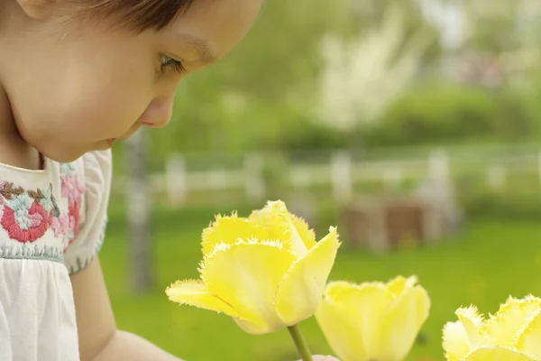 A good Caucasian baby in flowers — Stock Photo, Image