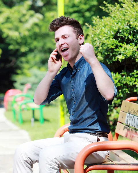 Happy young man on telephone — Stock Photo, Image