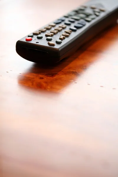 Remote Control and coffee table — Stock Photo, Image